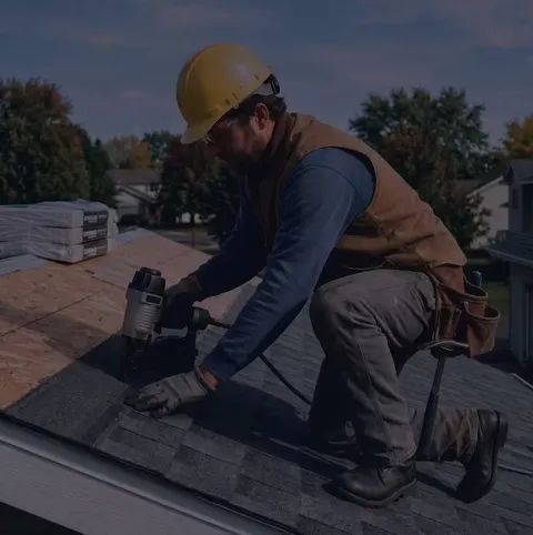 Roofing contractor fastening architectural shingles